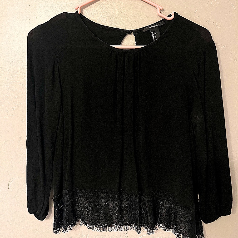Black blouse with three quarter length sleeves and eyelash lace trim